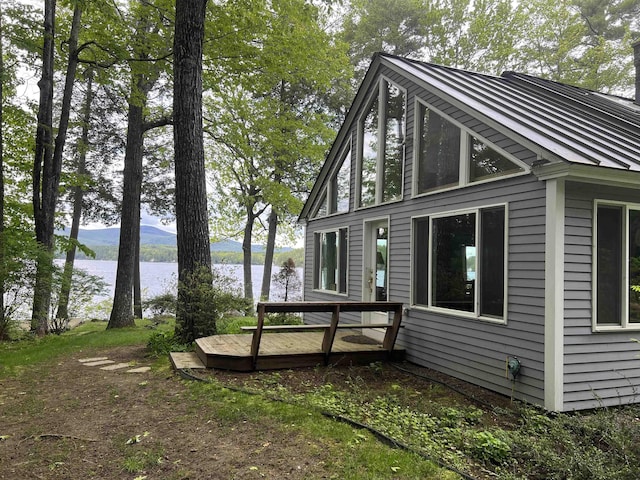 87 Chase Point Rd, Tuftonboro, NH 03853 - view of home's exterior featuring a deck with water view and metal roof