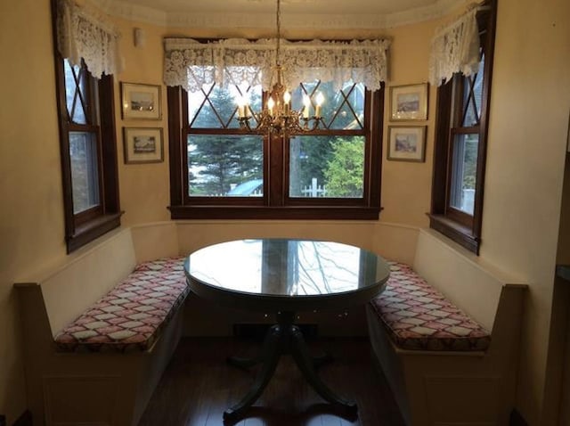 34 Baker Ave, Deerfield, NH 03037 - dining room featuring healthy amount of natural light, a chandelier, wood finished floors, and ornamental molding