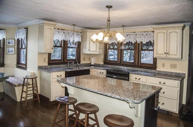 34 Baker Ave, Deerfield, NH 03037 - kitchen featuring black electric range, a kitchen bar, dark wood-style floors, a sink, and crown molding