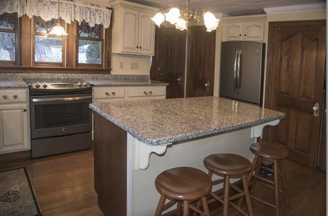 34 Baker Ave, Deerfield, NH 03037 - kitchen featuring appliances with stainless steel finishes, a center island, a chandelier, light stone countertops, and pendant lighting