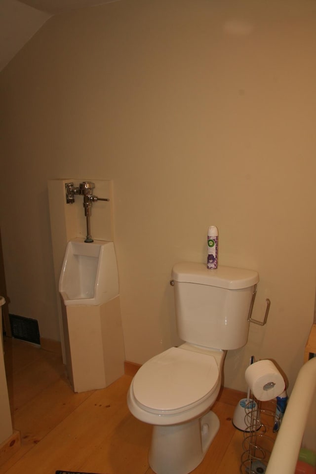 1083 Back Center Rd, Lyndon, VT 05851 - half bathroom with toilet, wood finished floors, and vaulted ceiling