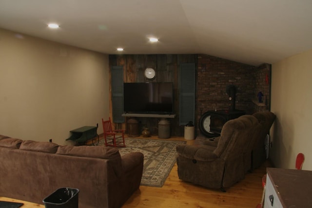 1083 Back Center Rd, Lyndon, VT 05851 - living area with a wood stove, light wood-type flooring, lofted ceiling, and recessed lighting