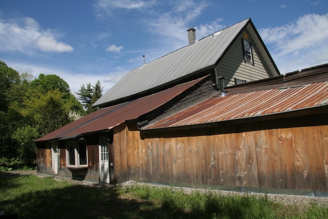 1083 Back Center Rd, Lyndon, VT 05851 - view of home's exterior with metal roof and a chimney