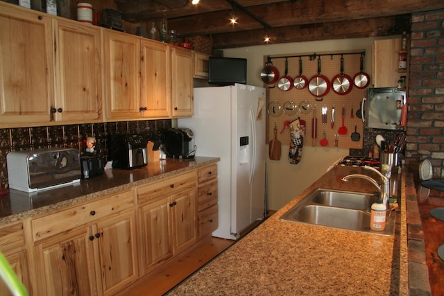 1083 Back Center Rd, Lyndon, VT 05851 - kitchen featuring a sink, white fridge with ice dispenser, light brown cabinetry, and brick wall
