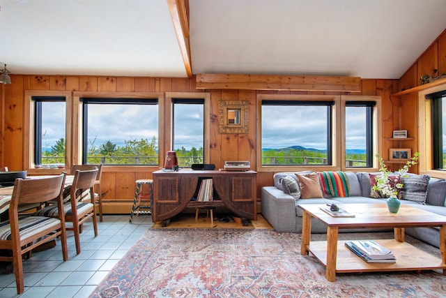 304 Green Bay Loop, Peacham, VT 05862 - living area featuring plenty of natural light, light tile patterned floors, wooden walls, and beamed ceiling