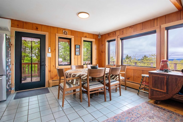 304 Green Bay Loop, Peacham, VT 05862 - dining room featuring light tile patterned floors, healthy amount of natural light, wood walls, and a wall mounted air conditioner