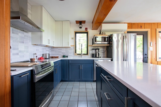 304 Green Bay Loop, Peacham, VT 05862 - kitchen featuring stainless steel appliances, wall chimney range hood, plenty of natural light, a wall unit AC, and wooden walls