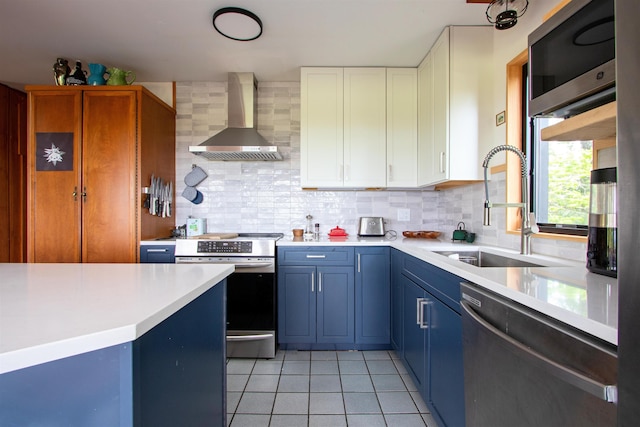 304 Green Bay Loop, Peacham, VT 05862 - kitchen with wall chimney range hood, appliances with stainless steel finishes, a sink, light tile patterned floors, and light countertops