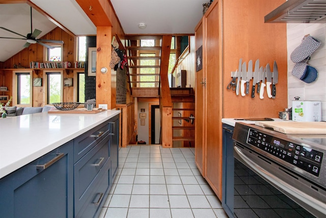 304 Green Bay Loop, Peacham, VT 05862 - kitchen featuring stove, wood walls, a ceiling fan, wall chimney range hood, and plenty of natural light