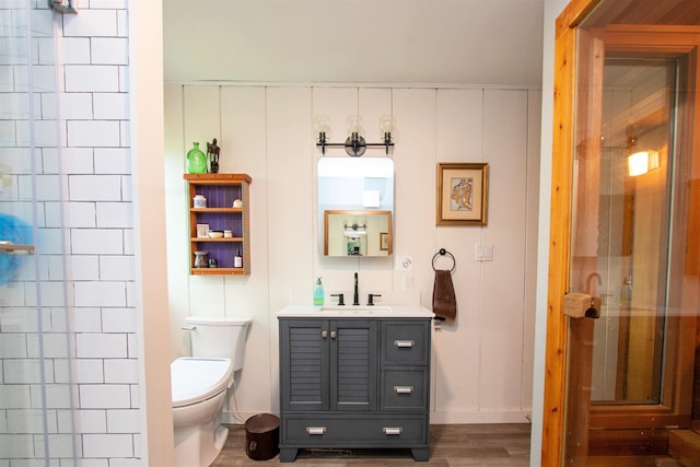 304 Green Bay Loop, Peacham, VT 05862 - bathroom with vanity, toilet, wood finished floors, a shower stall, and baseboards