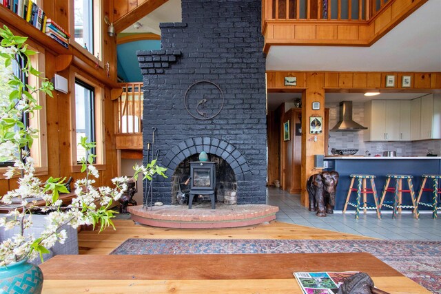 304 Green Bay Loop, Peacham, VT 05862 - tiled living area featuring a wood stove and a high ceiling