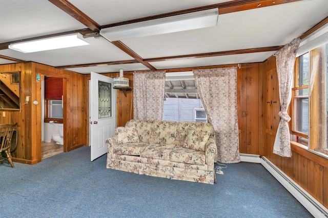 124 Hanson Rd, Ossipee, NH 03864 - unfurnished living room with wood walls, a baseboard radiator, and carpet