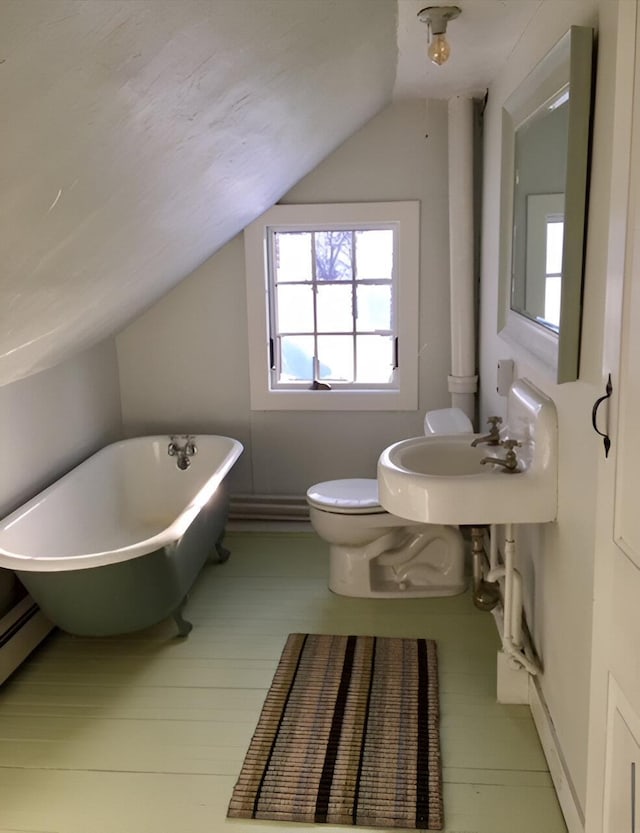 1186 Pucker St Unit 1.5Acres, Stowe, VT 05672 - bathroom with vaulted ceiling, a freestanding tub, a sink, toilet, and a baseboard heating unit