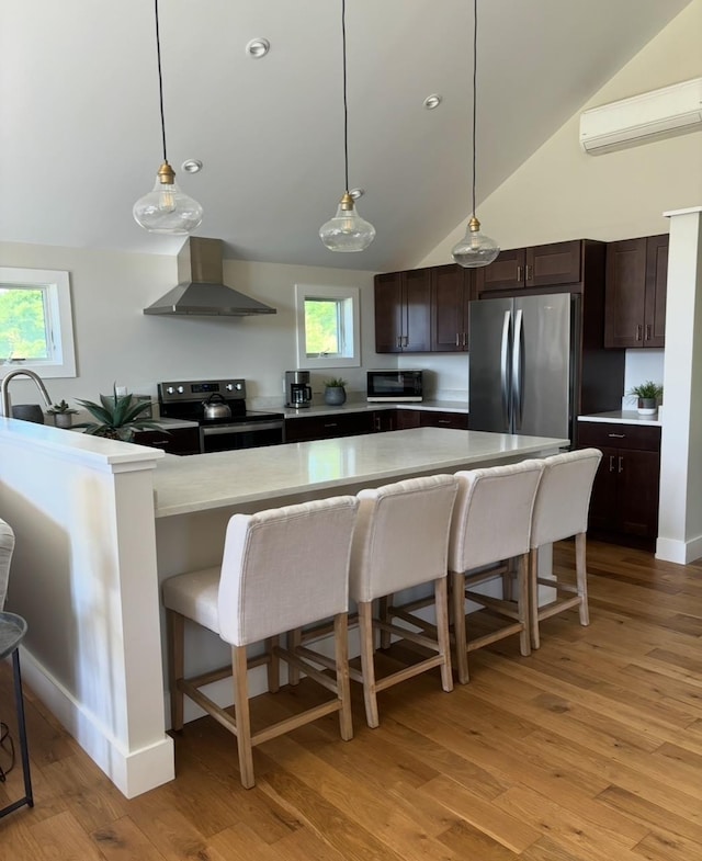 1186 Pucker St Unit 1.5Acres, Stowe, VT 05672 - kitchen with wall chimney range hood, freestanding refrigerator, electric stove, a wall unit AC, and a kitchen breakfast bar