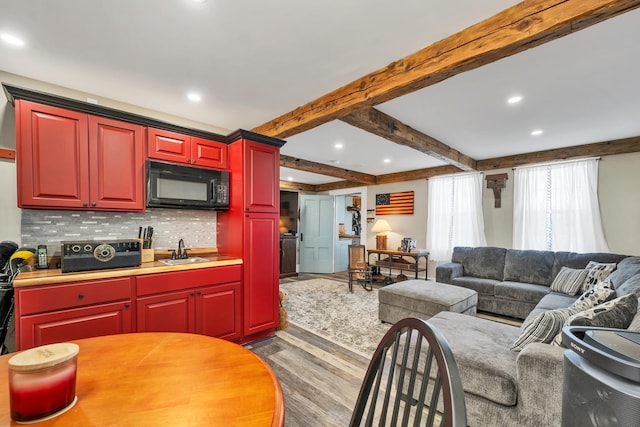 959 Presidential Hwy, Jefferson, NH 03583 - kitchen with black microwave, wood finished floors, backsplash, a sink, and recessed lighting