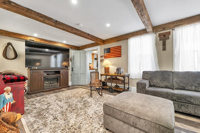 959 Presidential Hwy, Jefferson, NH 03583 - living area with wood finished floors, beamed ceiling, recessed lighting, baseboards, and a glass covered fireplace