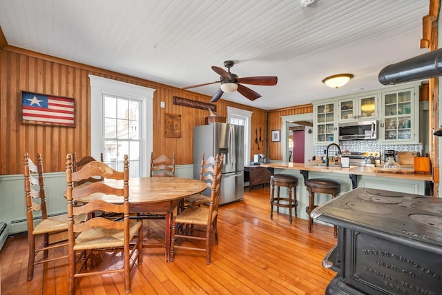 959 Presidential Hwy, Jefferson, NH 03583 - dining space featuring a ceiling fan, light wood-type flooring, and wooden walls