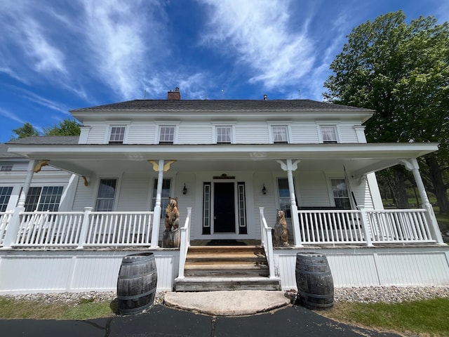 959 Presidential Hwy, Jefferson, NH 03583 - view of front of house with covered porch and a chimney