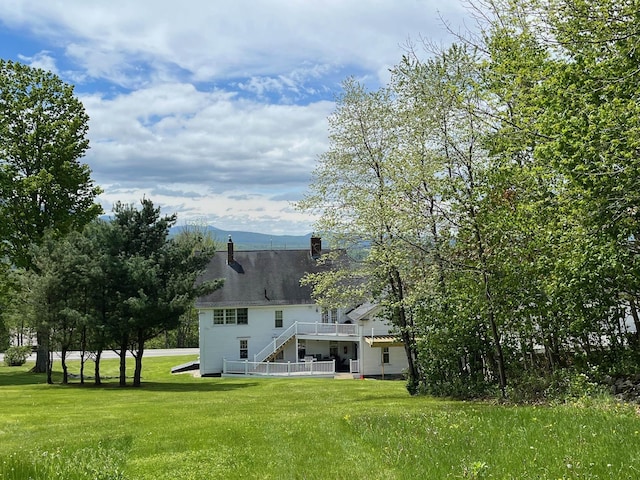 959 Presidential Hwy, Jefferson, NH 03583 - back of house featuring a yard, stairs, a wooden deck, and a chimney