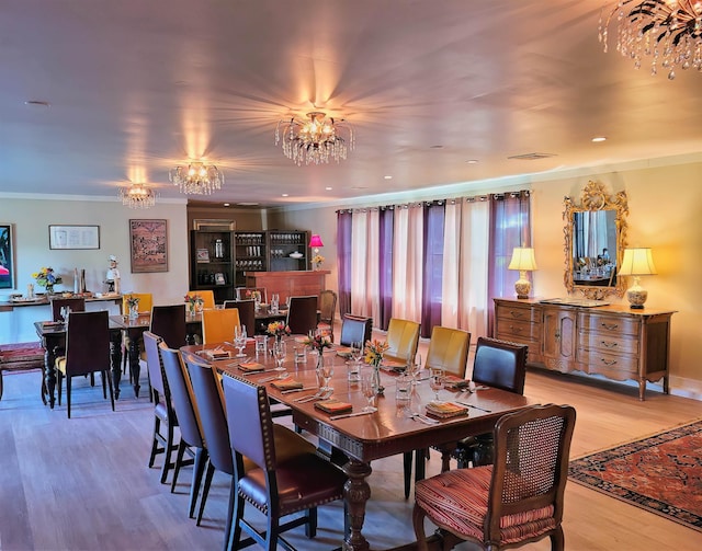 499 Andover Rd, New London, NH 03257 - dining space featuring a chandelier, wood finished floors, and ornamental molding