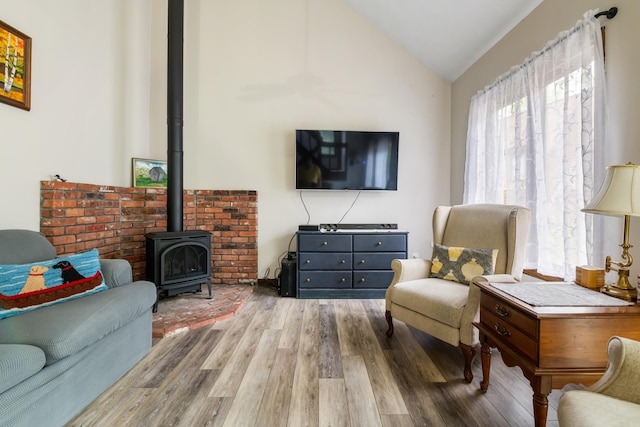 21 Pleasant Dr, Grantham, NH 03753 - living room featuring a wood stove, wood finished floors, and vaulted ceiling