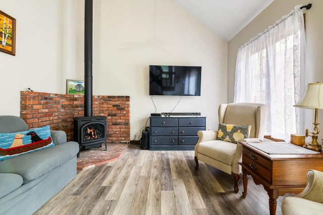 21 Pleasant Dr, Grantham, NH 03753 - living room with wood finished floors, a wood stove, and vaulted ceiling