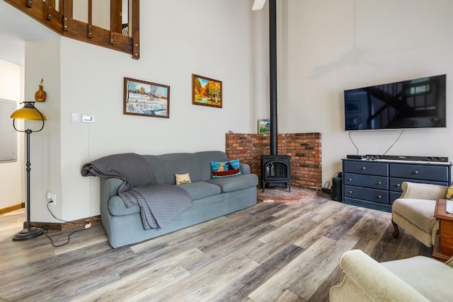 21 Pleasant Dr, Grantham, NH 03753 - living area featuring wood finished floors, a wood stove, and a towering ceiling