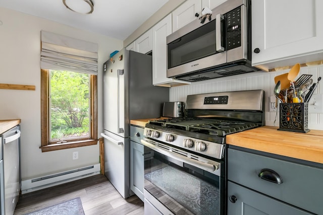 21 Pleasant Dr, Grantham, NH 03753 - kitchen featuring stainless steel appliances, wood counters, a baseboard heating unit, light wood-style flooring, and white cabinets