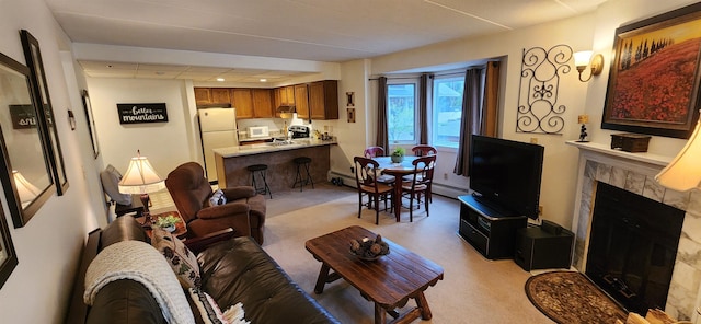 73 Alpine Dr Unit C211, Killington, VT 05751 - living area with a tile fireplace, light carpet, and a baseboard radiator