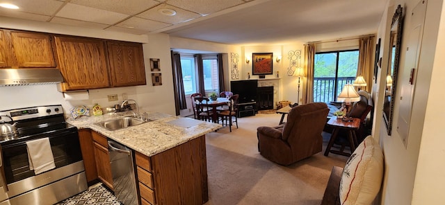 73 Alpine Dr Unit C211, Killington, VT 05751 - kitchen with appliances with stainless steel finishes, under cabinet range hood, a sink, open floor plan, and light colored carpet