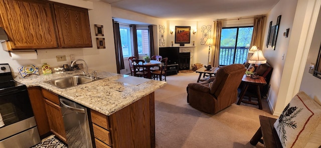 73 Alpine Dr Unit C211, Killington, VT 05751 - kitchen featuring a sink, appliances with stainless steel finishes, open floor plan, light carpet, and a fireplace with raised hearth