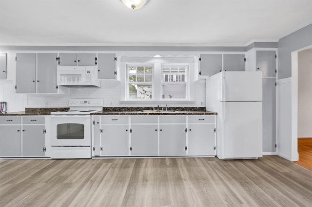 55 Washington St, Rochester, NH 03867 - kitchen featuring white appliances, a sink, light wood finished floors, backsplash, and dark stone countertops