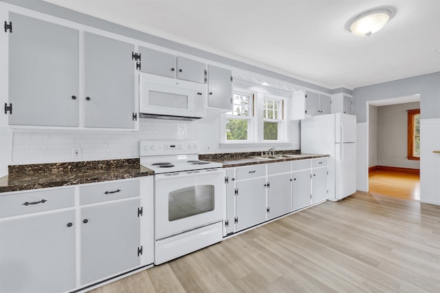 55 Washington St, Rochester, NH 03867 - kitchen with white appliances, light wood-style flooring, backsplash, and a sink