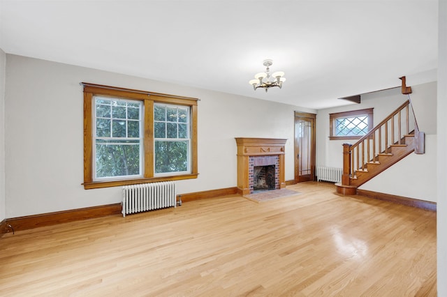 55 Washington St, Rochester, NH 03867 - unfurnished living room featuring radiator heating unit, stairs, and wood finished floors