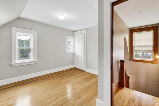 55 Washington St, Rochester, NH 03867 - unfurnished bedroom with light wood-type flooring, baseboards, and lofted ceiling