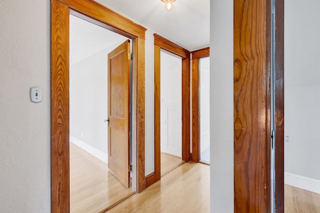 55 Washington St, Rochester, NH 03867 - hall with light wood finished floors, baseboards, and a textured wall