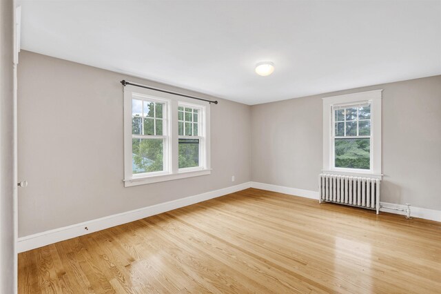 55 Washington St, Rochester, NH 03867 - empty room featuring radiator, wood finished floors, and baseboards