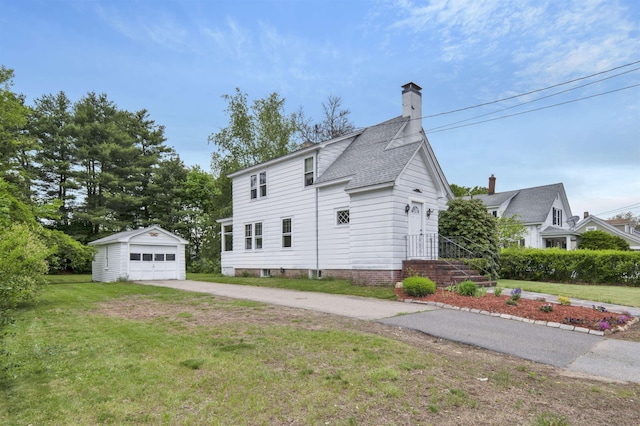 55 Washington St, Rochester, NH 03867 - view of side of property featuring concrete driveway, an outbuilding, a detached garage, a chimney, and a yard