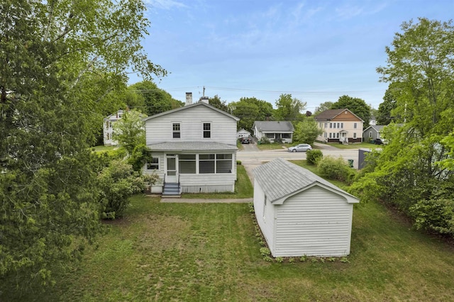 55 Washington St, Rochester, NH 03867 - back of property featuring entry steps, a yard, a shingled roof, and an outdoor structure