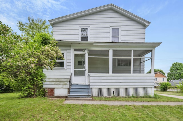 55 Washington St, Rochester, NH 03867 - view of front of home with a front yard, a sunroom, and entry steps
