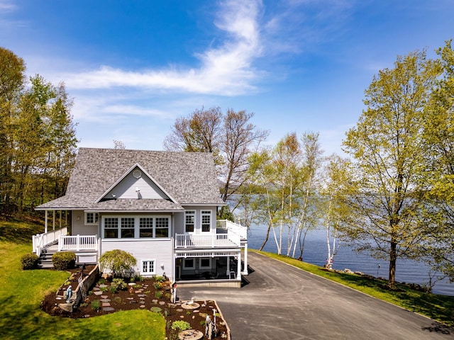 57 Farrants Pt, Newport City, VT 05855 - view of front of home with a shingled roof, driveway, and a front lawn
