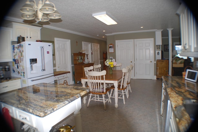 57 Farrants Pt, Newport City, VT 05855 - kitchen featuring white fridge with ice dispenser, white cabinets, a chandelier, ornamental molding, and stone countertops