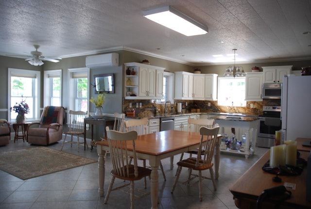57 Farrants Pt, Newport City, VT 05855 - dining space with an AC wall unit, crown molding, a ceiling fan, a chandelier, and tile patterned flooring