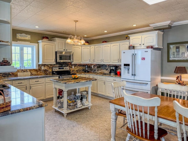 57 Farrants Pt, Newport City, VT 05855 - kitchen with stainless steel appliances, crown molding, backsplash, a chandelier, and hanging light fixtures