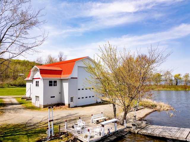 57 Farrants Pt, Newport City, VT 05855 - view of home's exterior with a gambrel roof, metal roof, a water view, dirt driveway, and a boat dock