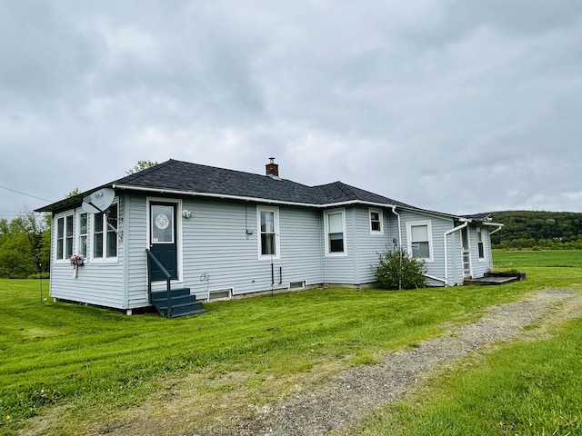 6998 River Rd, Lemington, VT 05903 - back of property featuring entry steps, a chimney, a lawn, and a shingled roof