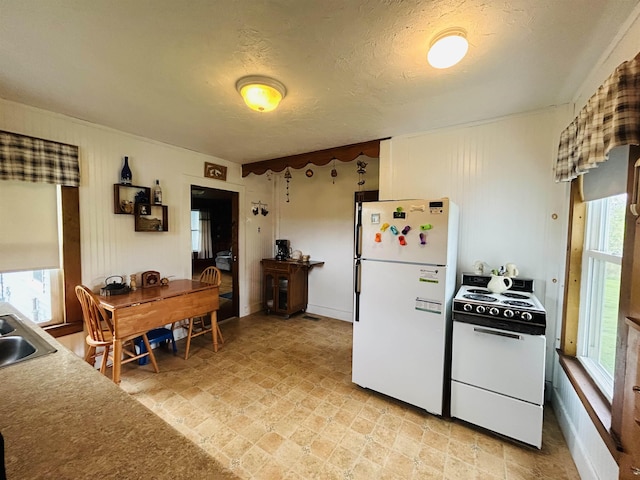 6998 River Rd, Lemington, VT 05903 - kitchen with white appliances, a sink, and a textured ceiling