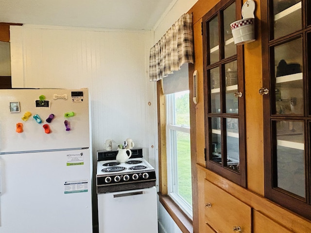 6998 River Rd, Lemington, VT 05903 - kitchen with white appliances, healthy amount of natural light, and glass insert cabinets