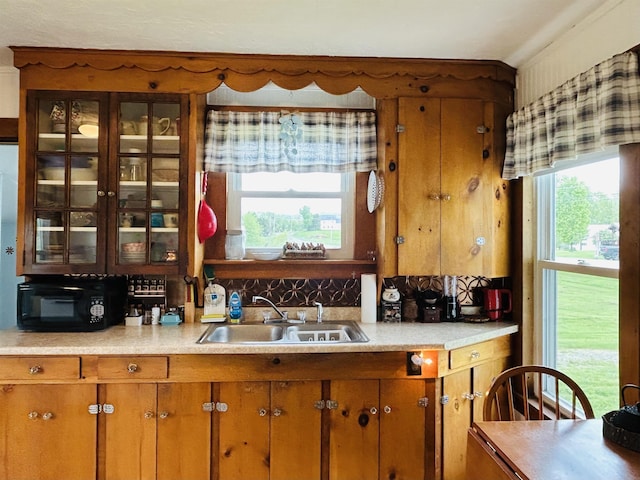 6998 River Rd, Lemington, VT 05903 - kitchen featuring a sink, black microwave, light countertops, and brown cabinets