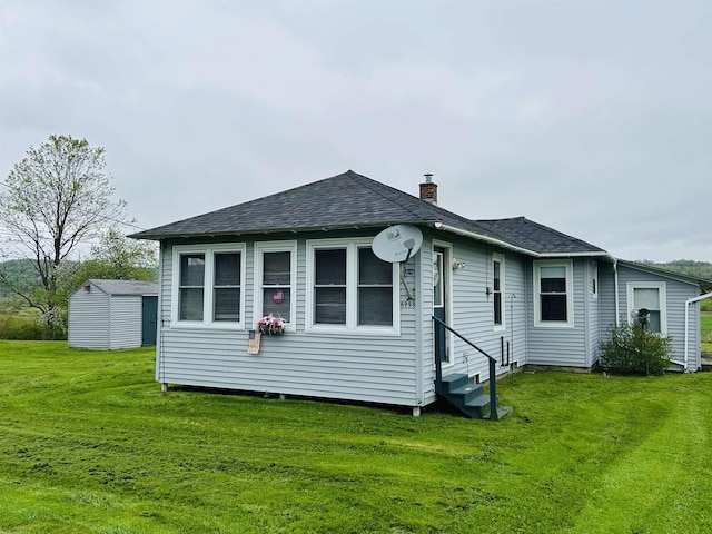 6998 River Rd, Lemington, VT 05903 - rear view of property featuring entry steps, a chimney, a lawn, and roof with shingles